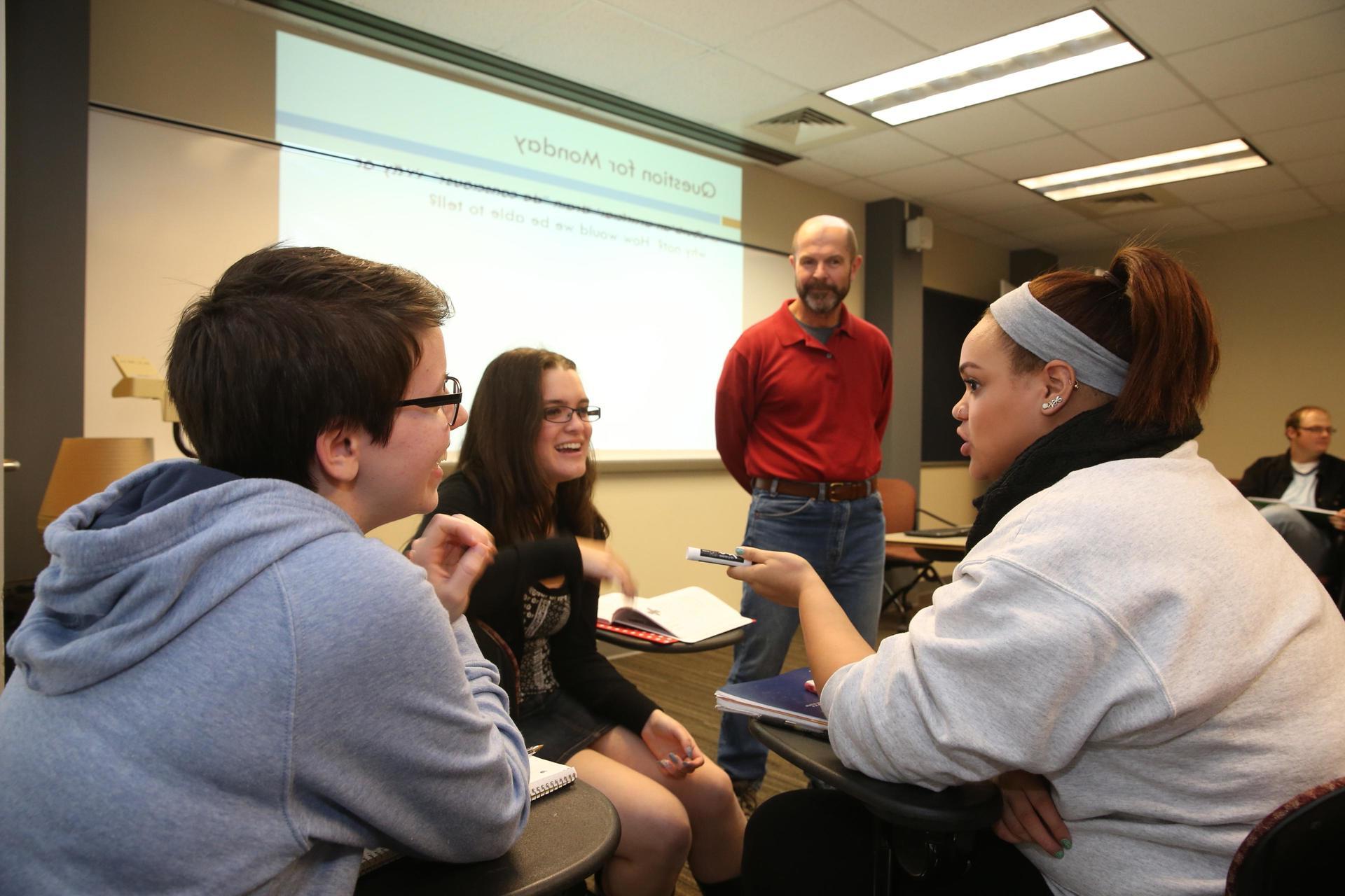 philosophy professor with students in classroom