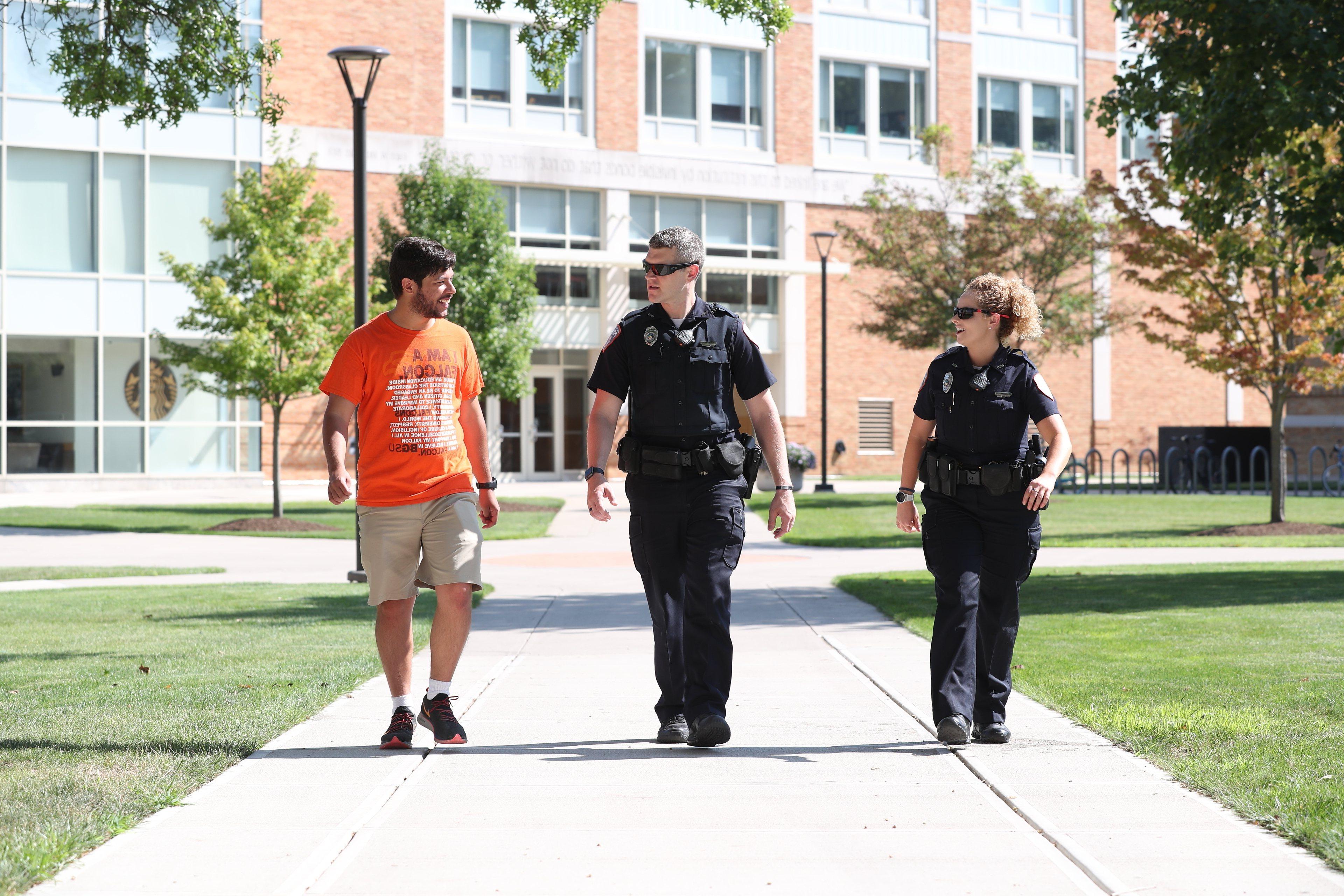 cops-and-student-walking-together-on-campus -